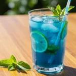 Ocean Blue Mojito Lemonade sugar free in a tall glass with mint and lime