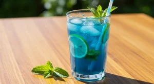 Ocean Blue Mojito Lemonade sugar free in a tall glass with mint and lime